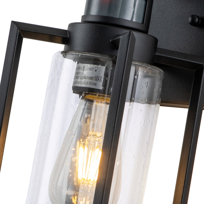 1-Light Matte Black Motion Sensing Dusk to Dawn Outdoor Wall Lanten with Clear Seeded Glass Cylinder