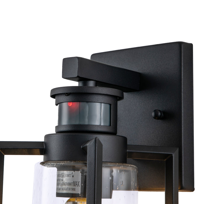 1-Light Matte Black Motion Sensing Dusk to Dawn Outdoor Wall Lanten with Clear Seeded Glass Cylinder