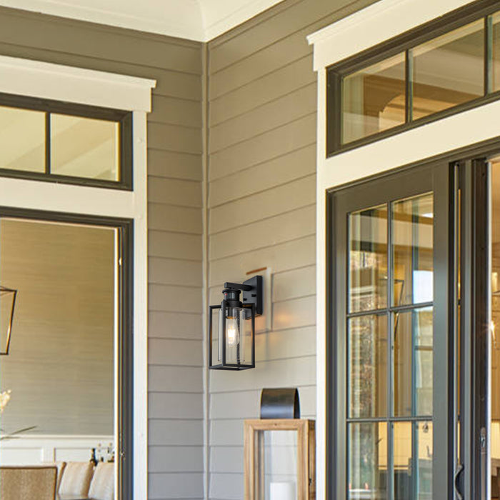 1-Light Matte Black Motion Sensing Dusk to Dawn Outdoor Wall Lanten with Clear Seeded Glass Cylinder